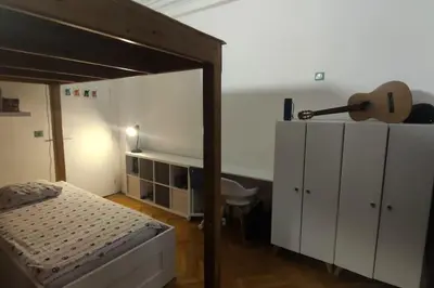 a bedroom with a bed and a guitar in it at Spacieux 4 pièces de type bourgeois Art-déco in Nice