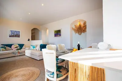 a living room with a couch and a table at LE PROVENCE AP4389 By Riviera Holiday Homes in Villefranche-sur-Mer