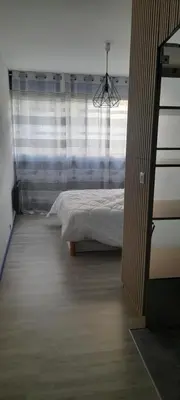 a bedroom with a bed and a large window at Chez Roland in Nice