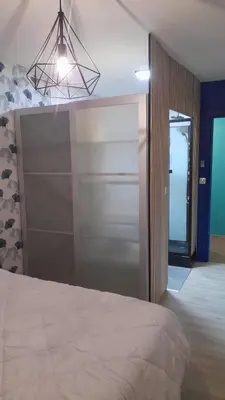 a bedroom with a bed and a sliding glass door at Chez Roland in Nice