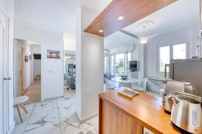 a kitchen and living room with white walls at FAMILY APARTMENT SEA VIEW in Nice