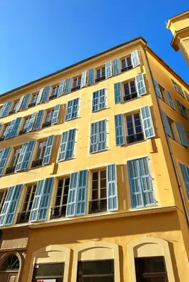 a yellow building with windows on the side of it at Modern apartment with AC near Old Nice & Beach in Nice