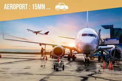 an airplane is parked on the runway at an airport at Appartements Nice Centre Proche Mer Carré d'Or in Nice