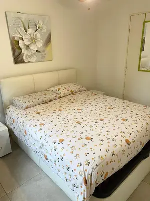 a bed with a floral comforter in a bedroom at bellissimo appartamento in Nice