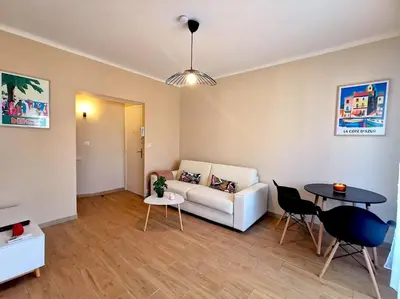 a living room with a couch and a table at Studio cosy - Proche mer et gare in Nice