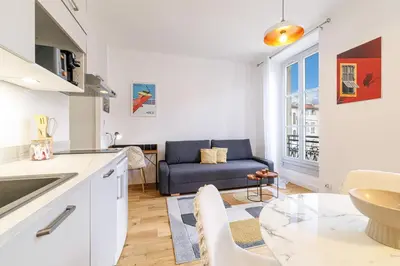 a kitchen and living room with a couch and a table at Charming City Center Studio 406 in Nice