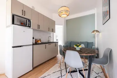 a kitchen and dining room with a table and chairs at Lovely 2 Bdr Nice Harbor in Nice
