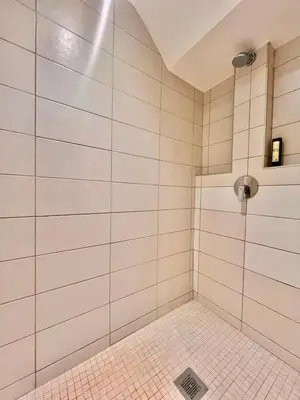 a bathroom with a shower with white tiles at Apartment Malaussena - Reception 24&7 - Center Libération in Nice