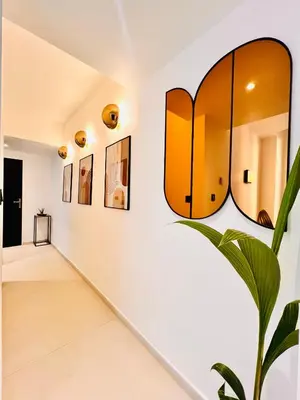 a hallway with a mirror and a plant at Apartment Malaussena - Reception 24&7 - Center Libération in Nice