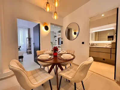a dining room with a table and chairs at Apartment Malaussena - Reception 24&7 - Center Libération in Nice