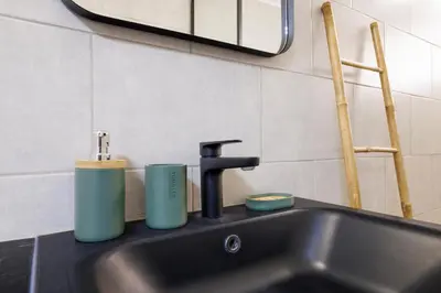 a kitchen sink with two cups and a faucet at NICE RENTING - PHILIBERT - Elegant Spacious Quiet Near the Port Free Parking in Nice