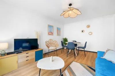 a living room with a blue couch and a table at NICE RENTING - PHILIBERT - Elegant Spacious Quiet Near the Port Free Parking in Nice