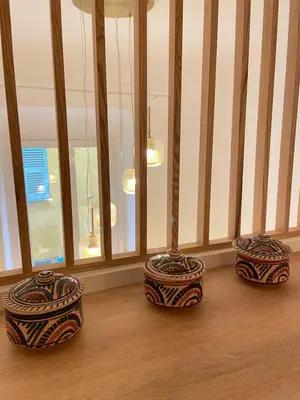 three vases sitting on the floor in front of a window at 2 pièces dans le Vieux Nice - à 3 min de la mer et du célèbre cours Saleya in Nice