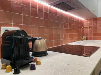 a kitchen with a coffee maker on a counter at 2 pièces dans le Vieux Nice - à 3 min de la mer et du célèbre cours Saleya in Nice