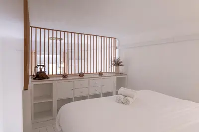 a white bedroom with a bed and a window at 2 pièces dans le Vieux Nice - à 3 min de la mer et du célèbre cours Saleya in Nice