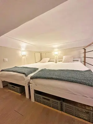 two beds sitting next to each other in a room at Elegant flat with AC, heart of old Nice, Walking to the Beach! in Nice