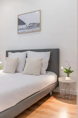 a bedroom with a bed and a table and a desk at Pertinax Cosy 2 pièces au coeur du centre ville de Nice AC in Nice