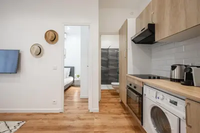 a white bathroom with a toilet and a shower at Pertinax Cosy 2 pièces au coeur du centre ville de Nice AC in Nice