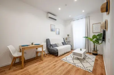 a living room with a bed and a kitchen at Pertinax Cosy 2 pièces au coeur du centre ville de Nice AC in Nice