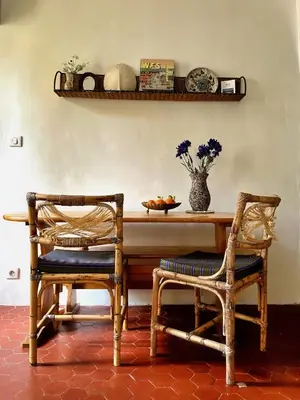 two chairs sitting next to a table with a bowl of fruit at Casa Marguerite, studio atypique in Nice