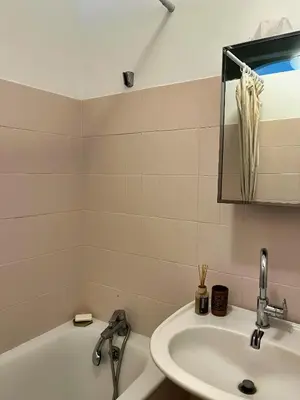 a bathroom with a sink and a tub and a mirror at Casa Marguerite, studio atypique in Nice