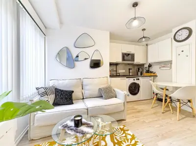 a living room with a couch and a table at Magnifique T2 neuf - résidence neuf- Hyper central in Nice