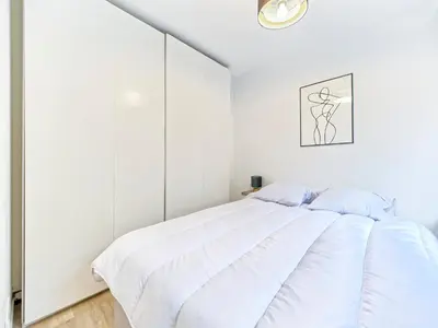 a bedroom with white walls and a white bed at Magnifique T2 neuf - résidence neuf- Hyper central in Nice