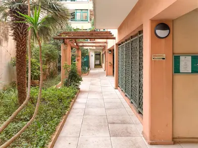 a walkway outside of a building with palm trees at Magnifique T2 neuf - résidence neuf- Hyper central in Nice