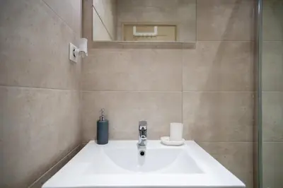 a bathroom with a white sink and a mirror at GuestReady - A peaceful stay near the marina in Nice