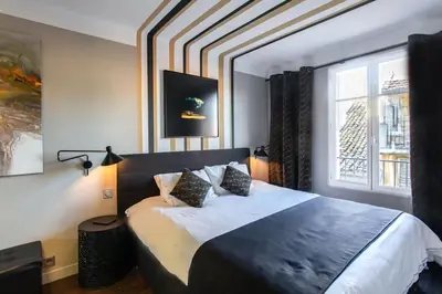a bedroom with a large bed and a window at #39 Old Town suite 3 BDR AC Balcony 5mins Walk to Sea in Nice