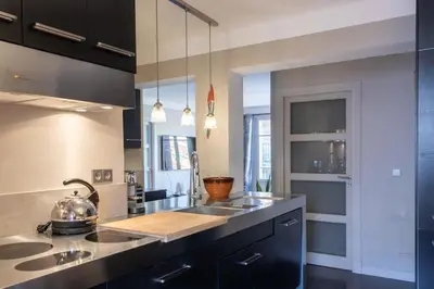 a kitchen with a sink and a counter top at #39 Old Town suite 3 BDR AC Balcony 5mins Walk to Sea in Nice