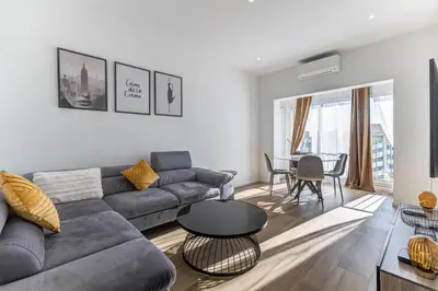 a living room with a couch and a table at Les Grands Cèdres - Wifi, AC, Parking in Nice