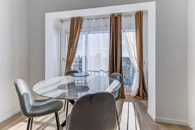 a dining room with a glass table and chairs at Les Grands Cèdres - Wifi, AC, Parking in Nice
