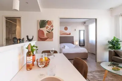 a living room with a bed and a table in a room at MY CASA - JOFFRE 2-4 - Bright Central 1 bedroom Near Massena in Nice