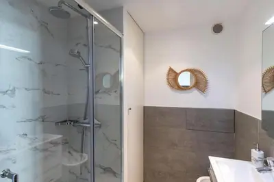 a bathroom with a shower and a sink and a mirror at MY CASA - JOFFRE 2-4 - Bright Central 1 bedroom Near Massena in Nice