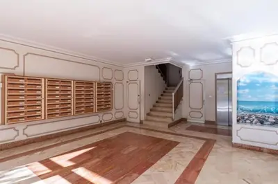 an empty room with a staircase and a wall with wooden shutters at MY CASA - JOFFRE 2-4 - Bright Central 1 bedroom Near Massena in Nice