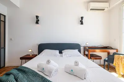 a bedroom with a white bed with two pillows on it at MY CASA - ETAT UNIS 93 INDIGO - Amazing Sea View Aprt with AC in Nice