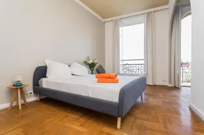 a bedroom with a bed with orange pillows on it at MY CASA - ETATS UNIS 894 - Stunning on Sea Front w AC in Nice