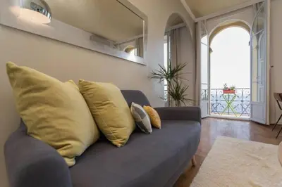 a blue couch with yellow pillows in a living room at MY CASA - ETATS UNIS 894 - Stunning on Sea Front w AC in Nice
