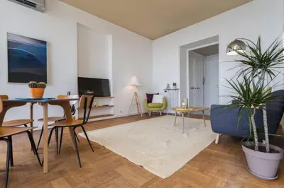 a living room with a table and chairs and a tv at MY CASA - ETATS UNIS 894 - Stunning on Sea Front w AC in Nice
