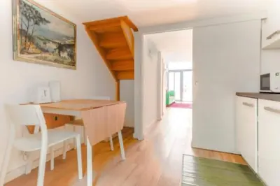 a kitchen and dining room with a table and chairs at Magnifique Duplex Type Loft in Nice