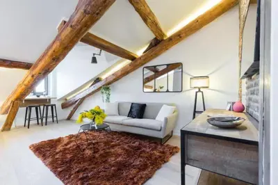 a living room with a couch and a table at MY CASA - MASSENA 44 - Stunning studio on Masséna Square in Nice