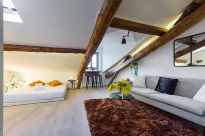 a living room with a couch and a table at MY CASA - MASSENA 44 - Stunning studio on Masséna Square in Nice