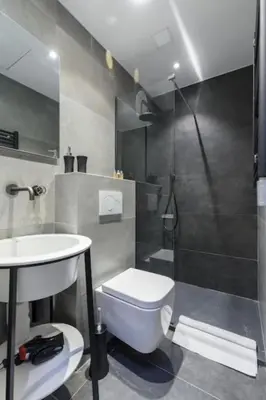 a bathroom with a toilet and a sink and a shower at MY CASA - MASSENA 44 - Stunning studio on Masséna Square in Nice