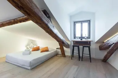 a white bedroom with a bed and a desk at MY CASA - MASSENA 44 - Stunning studio on Masséna Square in Nice