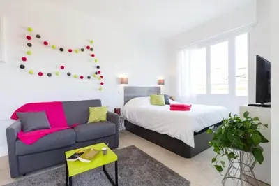 a living room with a couch and a bed at MY CASA - DALPOZZO - 5min walk to beach in Nice