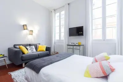 a bedroom with a bed and a couch at MY CASA - DROITE - Bright studio in the Old Town in Nice