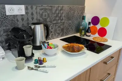 a kitchen counter with a table with food on it at MY CASA - DROITE - Bright studio in the Old Town in Nice