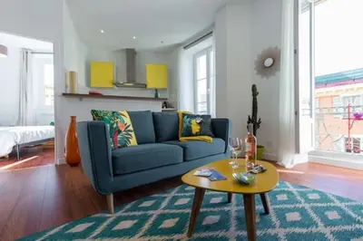 a living room with a blue couch and a table at MY CASA - GIOFFREDO 55 - 2 beds w AC on Massena Square in Nice