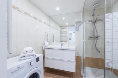 a bathroom with a washing machine and a sink at MY CASA - DELOYE - Spacious Quiet studio w AC near Old Town in Nice